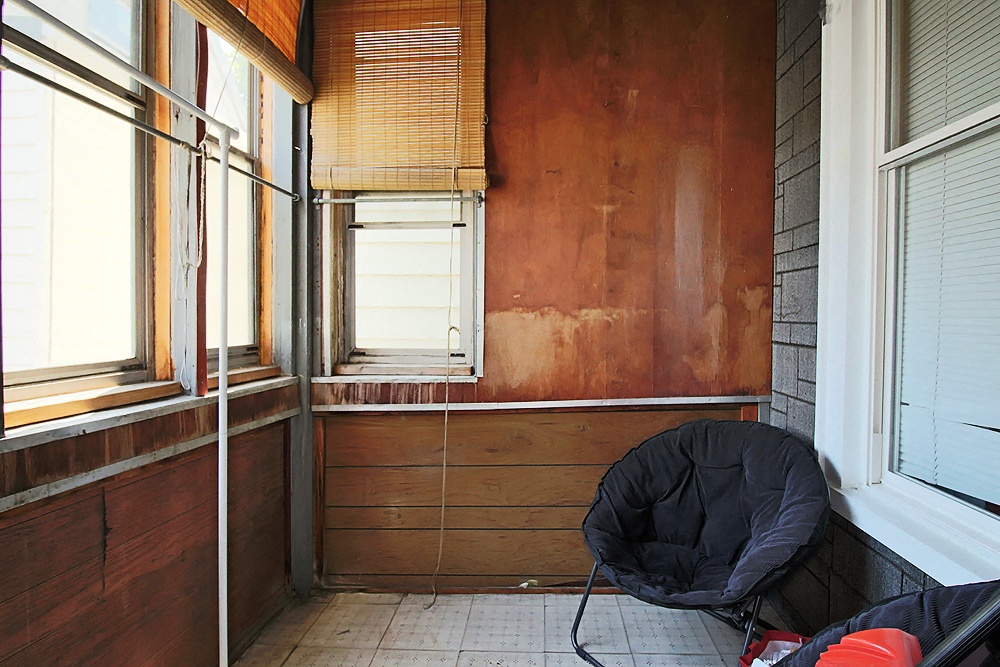 a room with a chair and a window in it